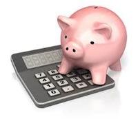 a pink piggy bank standing on a gray calculator