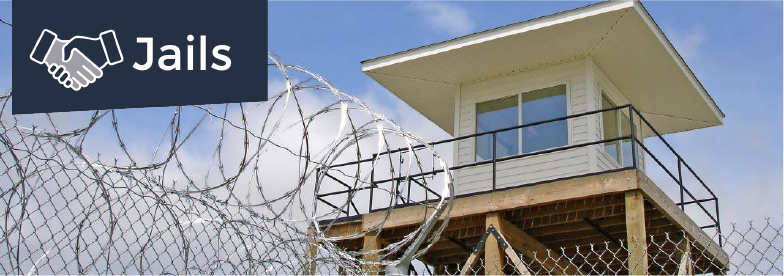 A watch tower with barbed wire and hurricane fencing, overlaid by the word Jails and a drawing of a handshake.