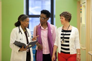 doctor, nurse, and social worker in hallway
